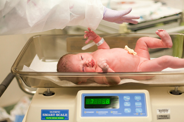 Thật nhanh chóng, em bé đã chào đời. Ngay sau đó, em bé được các y tá vệ sinh và đo cân nặng.
