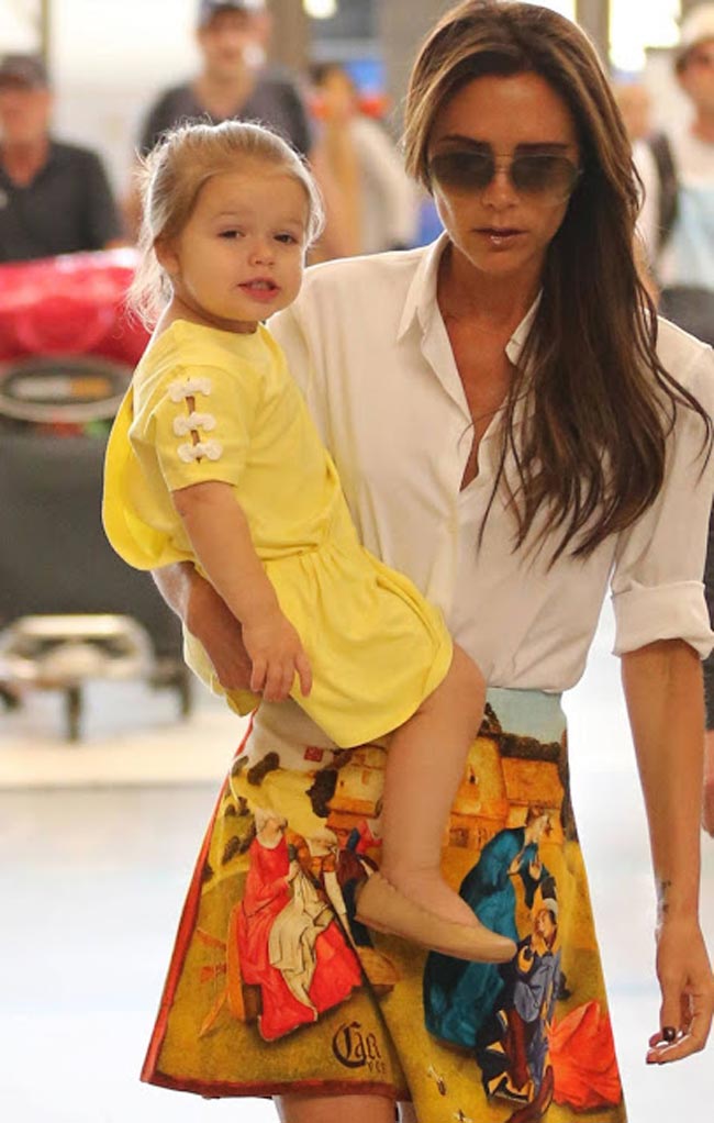 Harper và mẹ Vic bị bắt gặp tại sân bay LAX ngày 1.6, cô bé mặc một chiếc váy vàng chanh có nơ trắng đính vai của Chloe có giá 36 bảng Anh (hơn 1,2 triệu VND).
