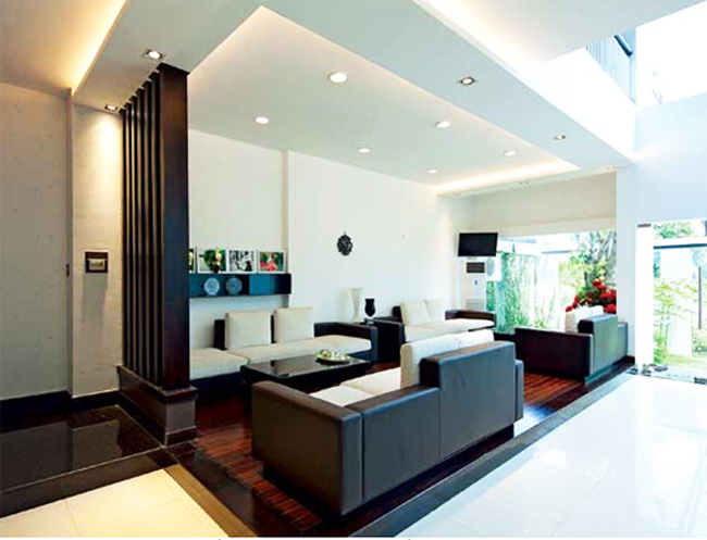 Phòng khách được phân chia mặc định bằng cao độ sàn và ánh sáng từ trần.
