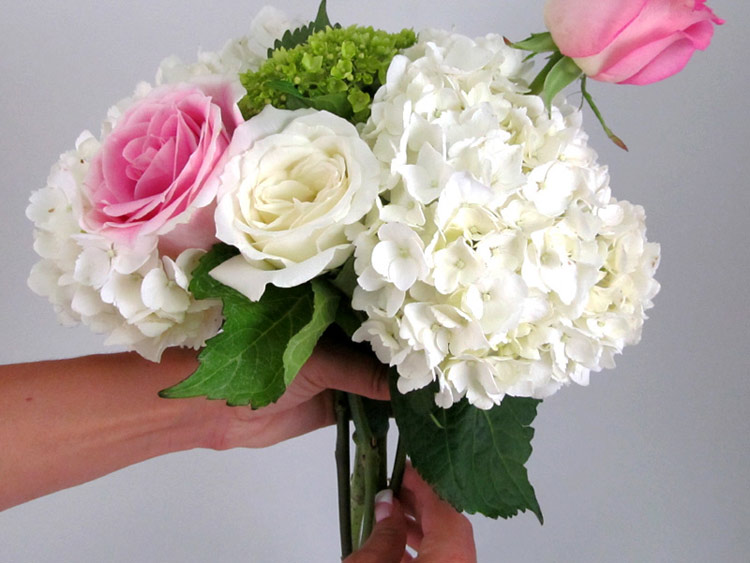 Tùy chỉnh màu sắc và số lượng hoa hồng thật đều quanh bó hoa cẩm tú cầu.

