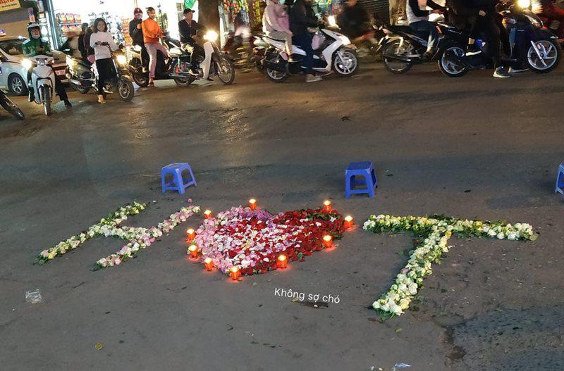 Tối 24/2, màn tỏ tình diễn ra trước cổng trường Đại học Văn hóa Hà Nội khiến nhiều người chú ý. Nam thanh niên công phu lấy hoa hồng trắng xếp thành tên viết tắt của anh và bạn gái, hoa hồng đỏ và nến lung linh kết thành một hình trái tim to đặt ở giữa.
