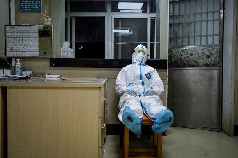 Một nhân viên y tế đang tranh thủ nghỉ ngơi ca đêm trong khi vẫn còn đang mặc nguyên bộ đồ bảo hộ trên người hôm 9/2. Đây là một trung tâm y tế tại quận Thanh Sơn, thành phố Vũ Hán, tỉnh Hồ Bắc, Trung Quốc.
