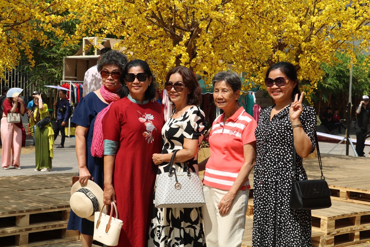 Ngoài đường mai vàng, điểm thu hút khách của phố ông đồ năm nay còn có sự xuất hiện vô số tiểu cảnh tái hiện hình ảnh Tết xưa như cổng nhà ba gian, không gian làng nghề nón lá với 300 chiếc nón, bức tường gốm được thiết kế từ 600 chậu gốm được xếp chồng lên nhau. Và những bếp củi nấu bánh, vườn cúc mâm xôi đủ sắc màu... tạo nên một không gian Tết độc đáo giữa phố.