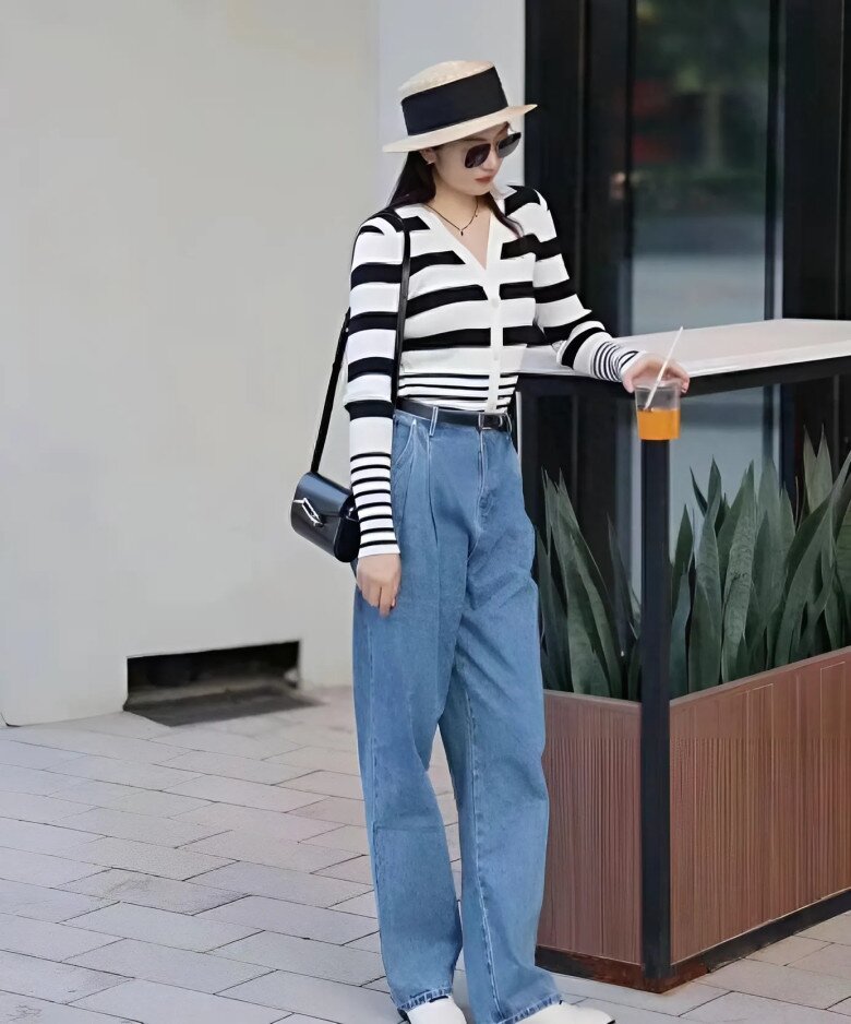 Áo khoác cardigan sơ vin với quần ống rộng cạp cao, điểm thêm chiếc thắt lưng giúp nhấn eo, tạo nên tỷ lệ cơ thể đẹp mắt và gọn gàng.