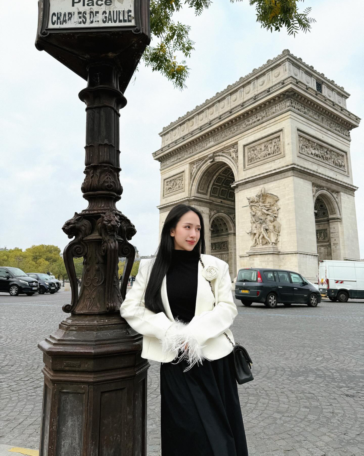 Joyce Phạm diện blazer đính lông vũ điệu đà check-in ở Khải Hoàn Môn.