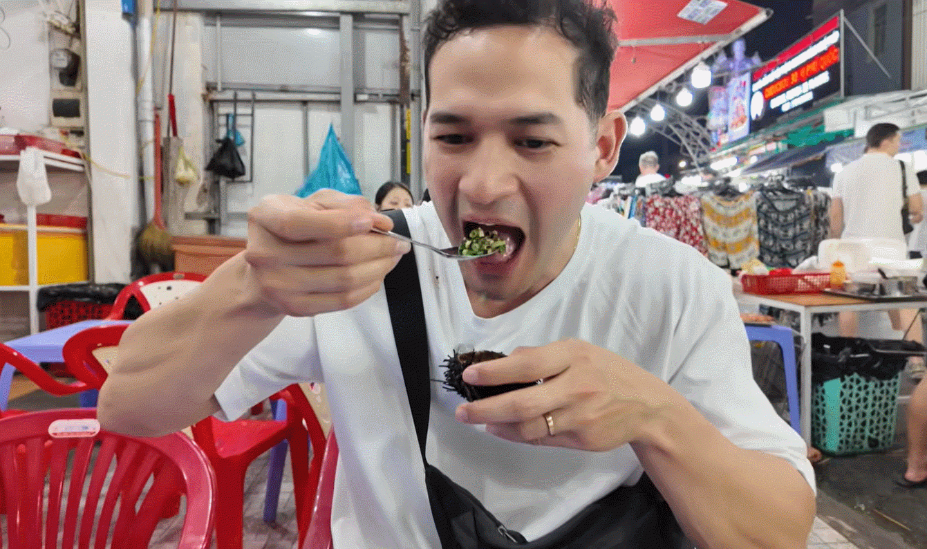 Nam du khách thể hiện biểu cảm thích thú, hài lòng khi trải nghiệm món ăn được ví như nhân sâm của biển ở Việt Nam