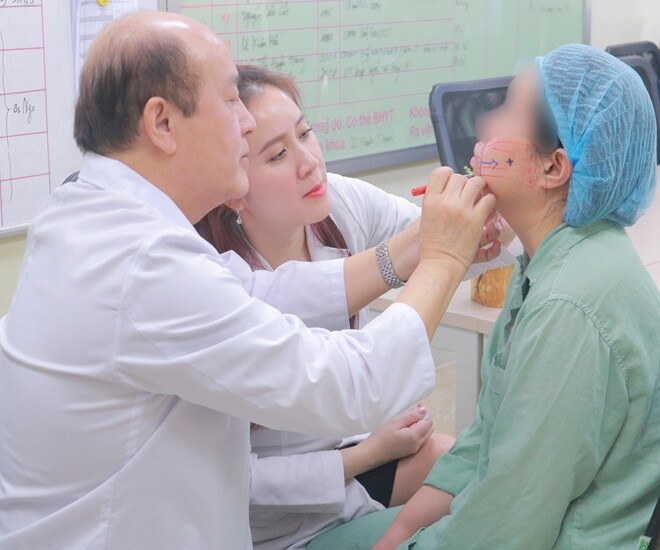 Chuyên gia và bác sĩ Bệnh viện E thăm khám cho bệnh nhân trước khi thực hiện phẫu thuật.