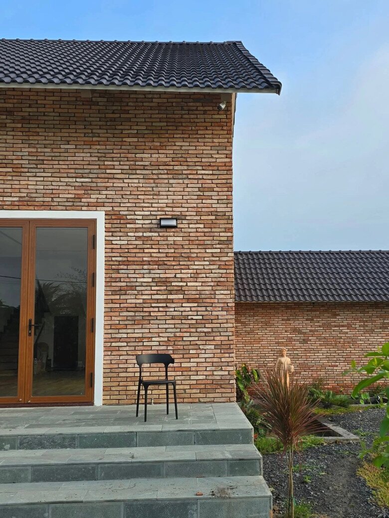 Gam màu đỏ nâu của gạch kết hợp với hệ thống cửa kính lớn tạo nên vẻ đẹp bền vững, hài hòa với cảnh quan xung quanh.