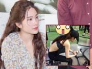 Làng sao - Hình ảnh cô gái được cho là Nam Em đang ngồi xem ảnh Trường Giang tại phòng tập gym