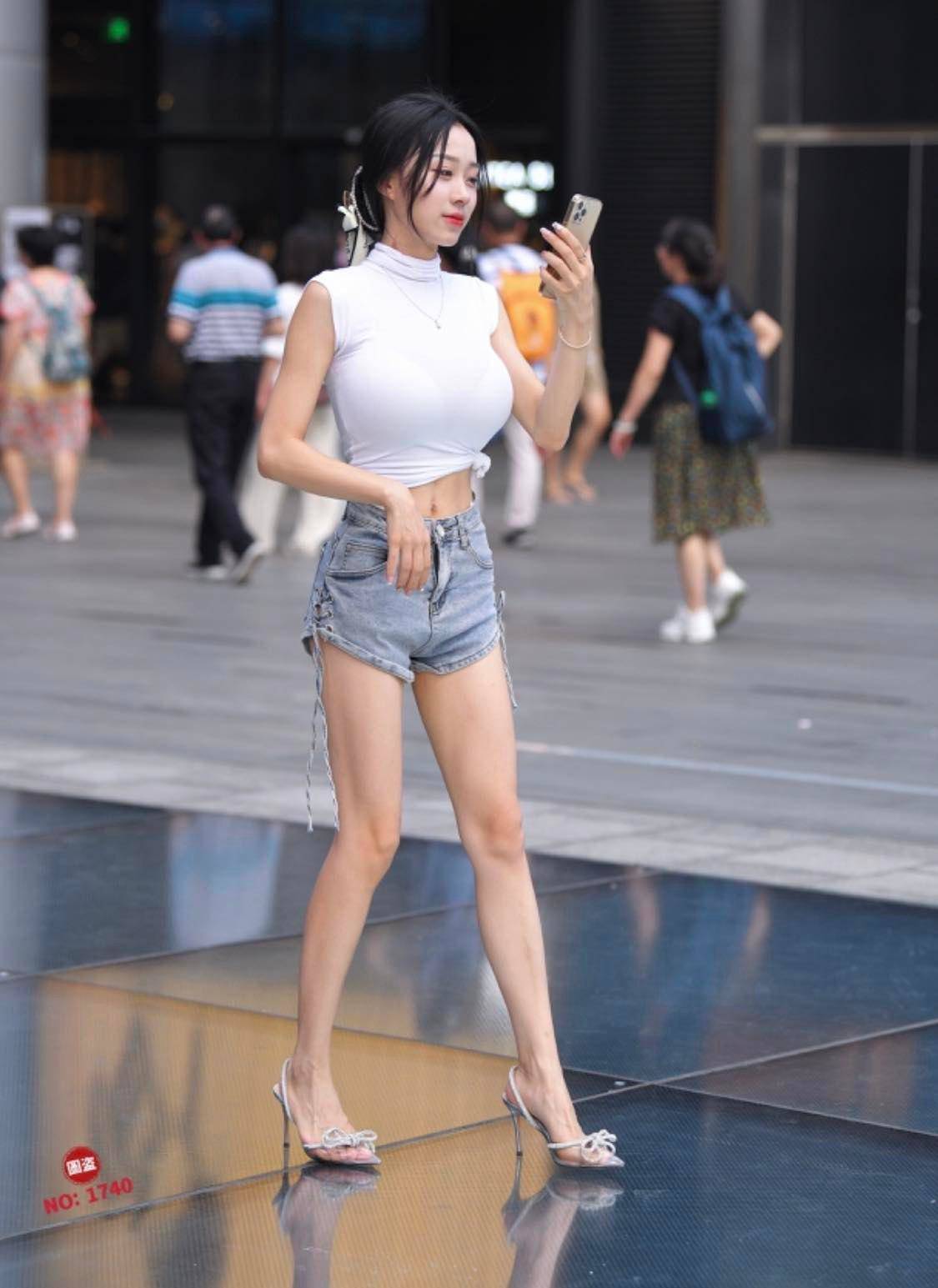 The beauty with an oversized bust loses points because of the stretchy shirt on the street - 4