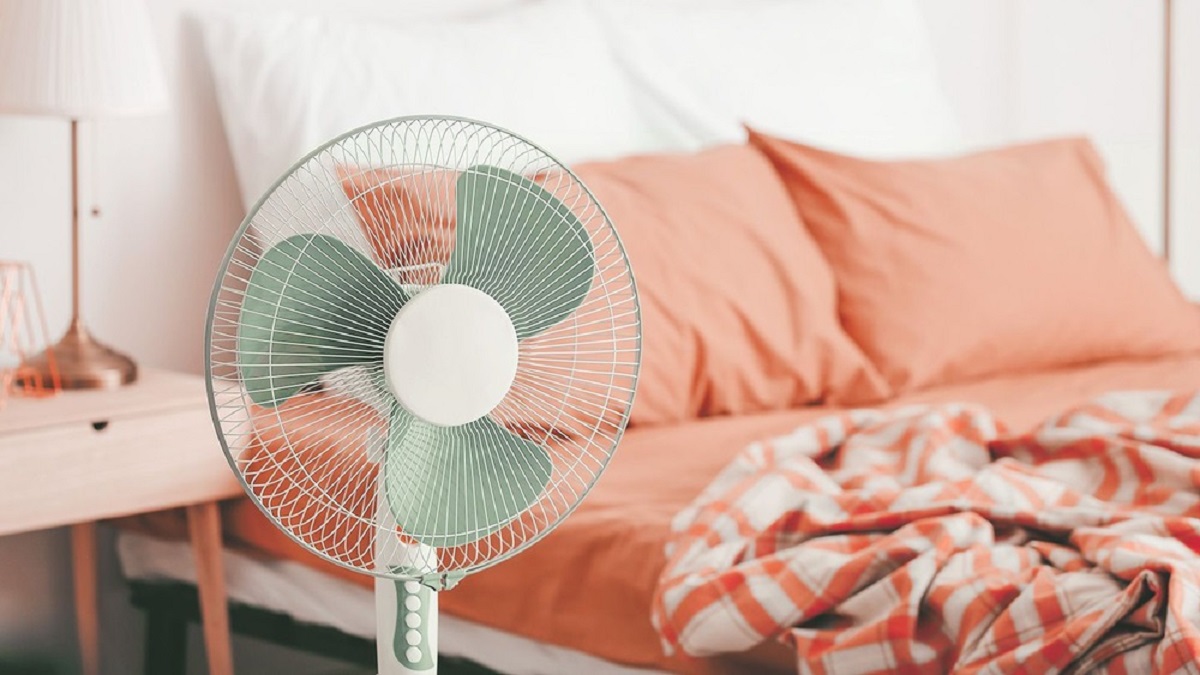 Woman with fan and air conditioning