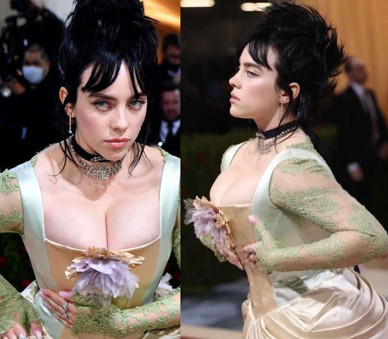 Billie Eilish tại Met Gala 2022 đã "đốt mắt" cánh phóng viên lẫn người hâm mộ với thiết kế mang âm hưởng của thời kỳ Phục Hưng là váy đầm bồng bềnh, đai corset định hình vòng eo và chân ngực.
