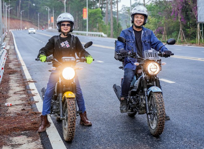 Huy and his mother posing with their motorcycles