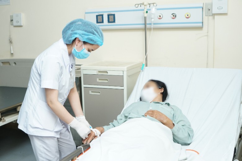 Bà Hương được nhân viên y tế chăm sóc sau phẫu thuật. Ảnh: BVCC.