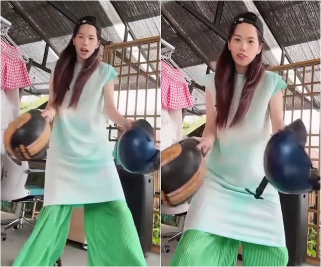 Nam Em cầm mũ bảo hiểm đòi boxing với những ai chửi mắng mình.
