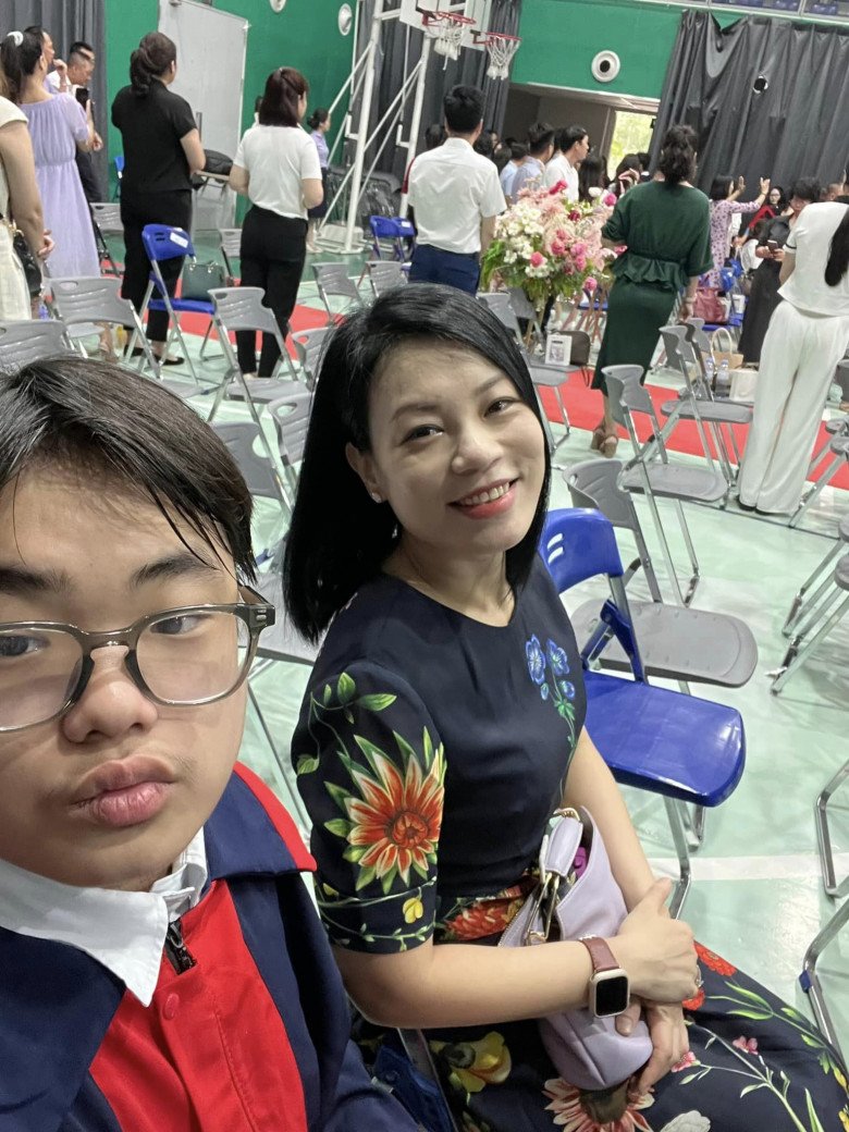 Con trai Xuân Bắc vui vẻ cầm điện thoại selfie cùng mẹ. Vợ Xuân Bắc gây chú ý khi xuất hiện trong lễ của con với trang phục trang nhã mà không kém phần tươi tắn.