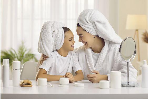 Baby sunscreen bottle and a mother gently applying it on her baby