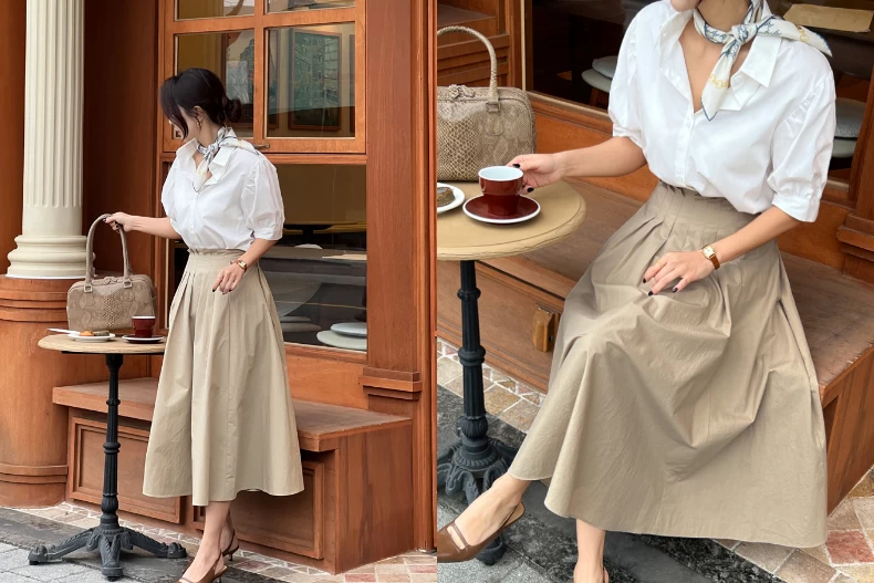 Một lựa chọn kinh điển nhưng không bao giờ lỗi thời là áo sơ mi trắng kết hợp với chân váy dài màu be vừa sạch sẽ, gọn gàng lại vừa toát lên sự dịu dàng.