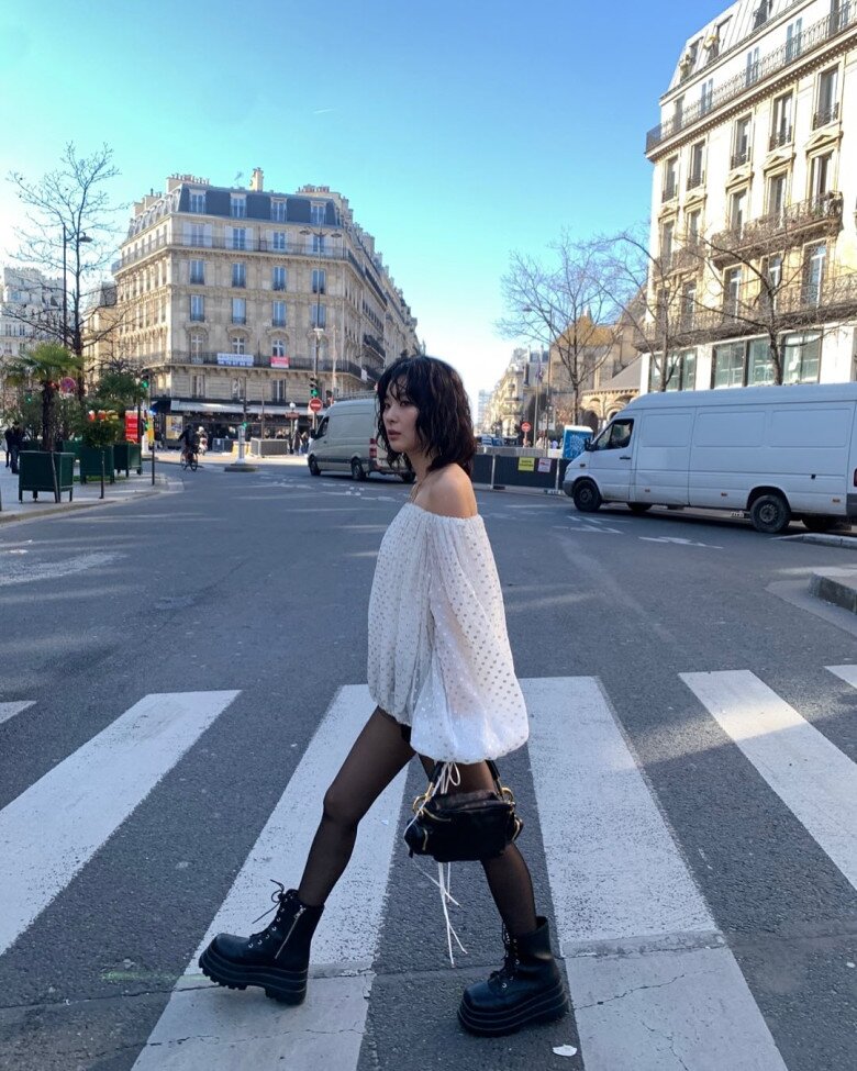 Đi dạo trên đường phố Pháp, Seulgi cũng nổi loạn với style giấu quần, kết hợp quần tất lưới đen và trung hòa với kiểu áo trắng tay thụng có phần nữ tính, thanh khiết, tương phản với những item còn lại