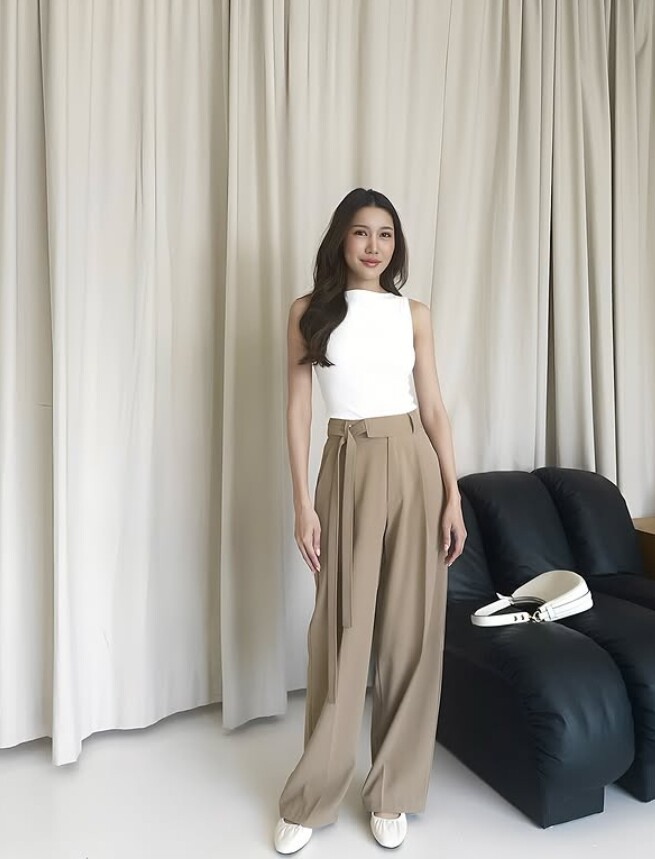 Set đồ đơn sắc với áo trắng không tay và quần ống rộng màu nâu nhạt tôn lên làn da sáng và vóc dáng thon gọn.