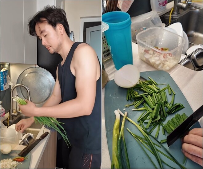 Nam diễn viên tiếp tục xử lý phần rau thơm – rửa và cắt hẹ thành từng khúc nhỏ, chuẩn bị sẵn sàng cho phần nước tương đậm đà. Mặt thớt đầy nguyên liệu: Hẹ, hành, tỏi, tất cả đã sẵn sàng để phối trộn cùng nước tương tạo nên hỗn hợp nước sốt cực hấp dẫn.