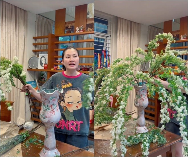 Ngọc Lan tự tay cắm một bình hoa tiểu tú cầu trắng, kiểu dáng vòm buông rủ tự nhiên. Lọ hoa sứ cổ điển vẽ hoa văn hồng nhạt góp phần làm dịu không gian phòng với tông gỗ ấm và rèm be nhẹ nhàng.