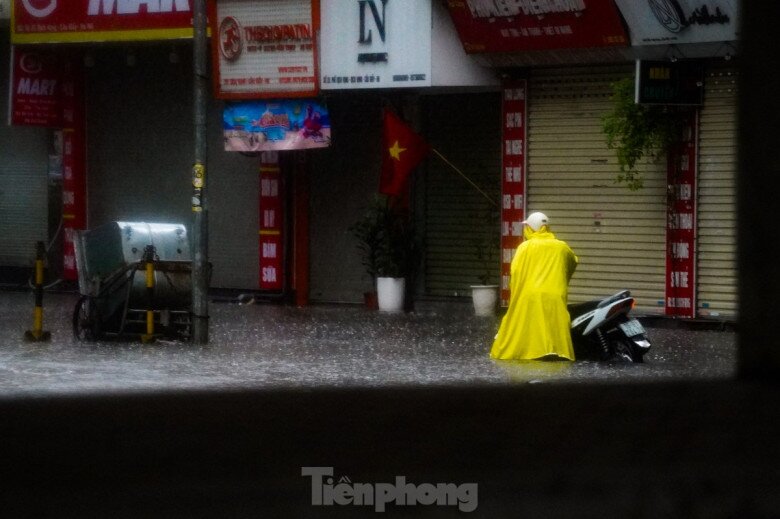 Xe hỏng máy, người điều khiển phải xuống dắt bộ giữa dòng nước ngập.