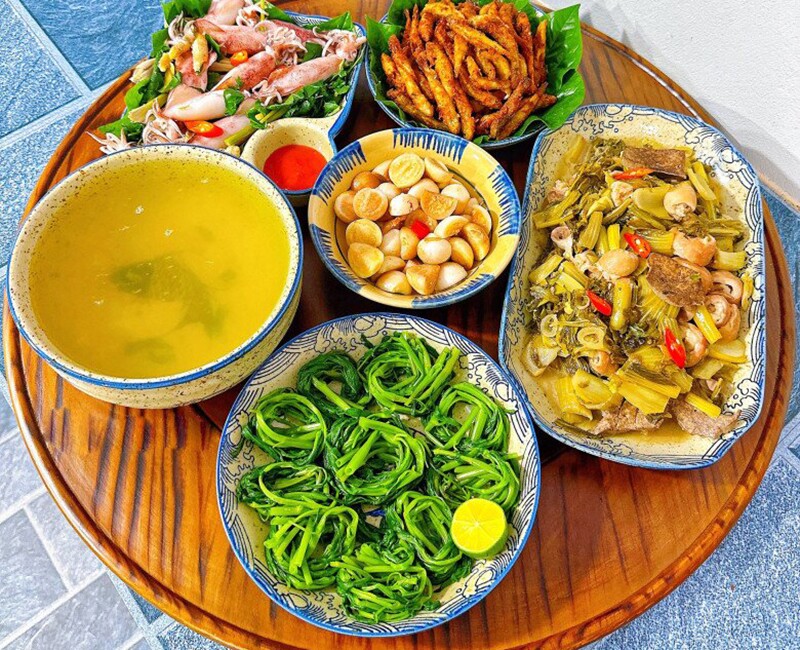 Mâm cơm này gồm các món: Lòng xào dưa, mực hấp, rau muống luộc, bống chiên giòn, cà muối (Ảnh: Phạm Hằng)