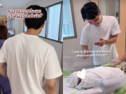 Yêu con - Chồng Á hậu Chế Nguyễn Quỳnh Châu cẩn thận xem hình trên điện thoại trước khi nhận con từ điều dưỡng bệnh viện