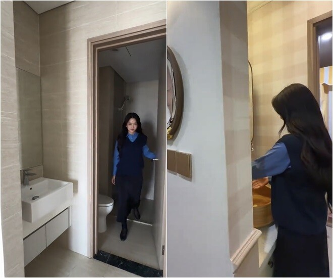 Khu vực vệ sinh và phòng tắm được lát đá marble vân mây sang trọng, mang lại cảm giác sạch sẽ và hiện đại. Cách sử dụng gương lớn cùng ánh sáng vàng ấm áp giúp không gian này trở nên rộng rãi, thư thái như ở spa.