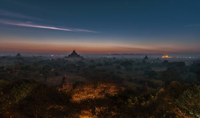 Khung cảnh lúc sáng tinh mơ trên những ngôi đền cổ nằm giữa rừng cây rộng lớn.
