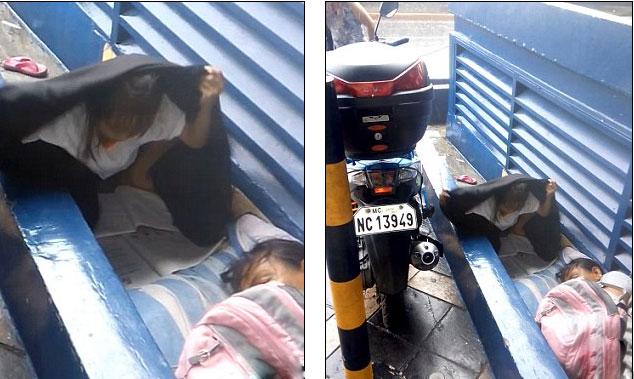 Bé gái Philppines che ô làm bài tập dưới trời mưa tầm tã - 1