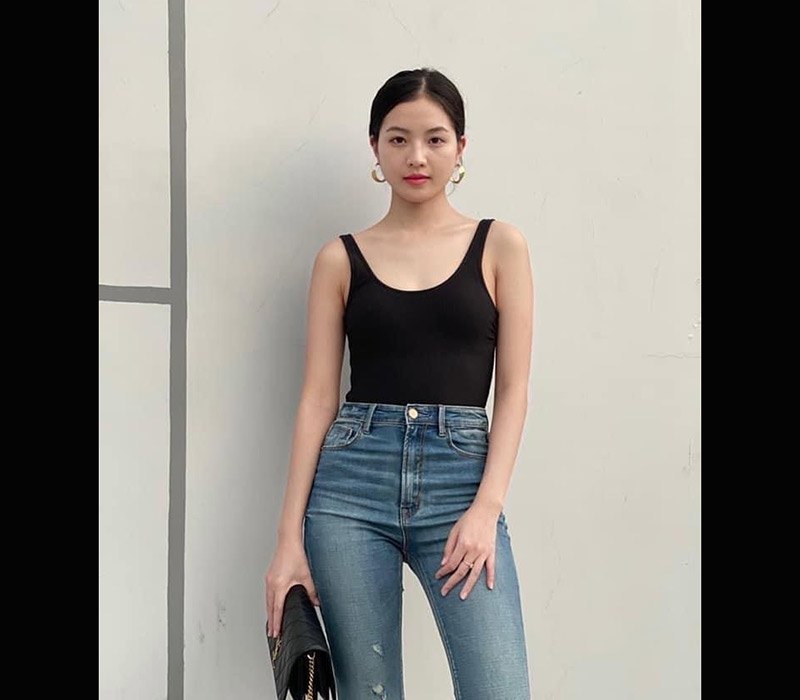 Áo hai dây màu đen mix kèm với quần jeans cạp cao giúp đôi chân được kéo dài, mang lại tỷ lệ hình thể hoàn hảo cho người mặc.
