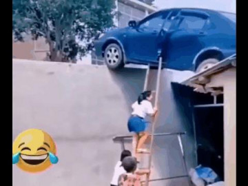  Clip: Nữ tài xế lùi ô tô lên mái nhà, người dân bắc thang giải cứu 