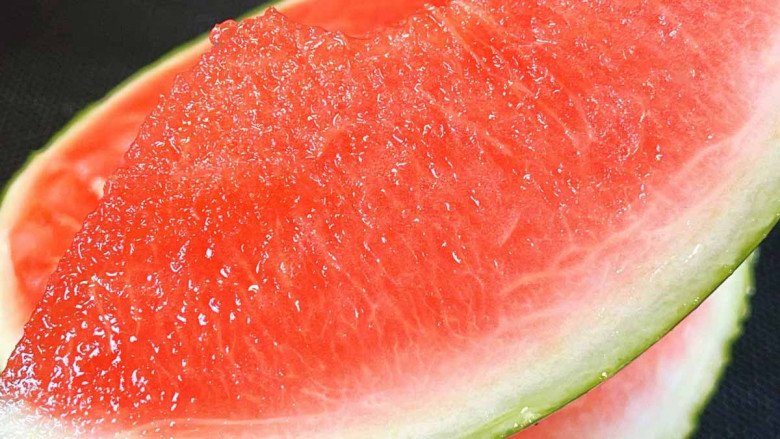 A slice of watermelon on a blue plate