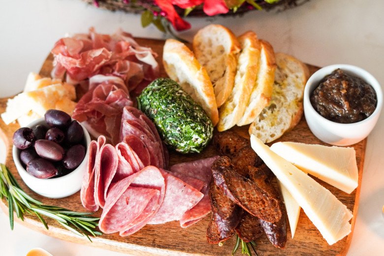 Image of a beautifully arranged cold cut platter with meats, cheeses, and accompaniments