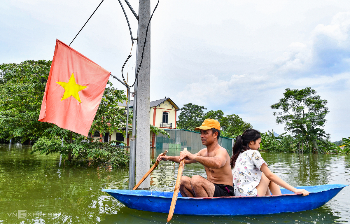 Anh Duy Phước thôn Nam Hài, xã Nam Phương Tiến cùng con gái đi thuyền vào nhà lấy thêm đồ sinh hoạt. Nhà tôi có 8 người, nước lên cao sát tới nóc nên mọi người chạy hết sang nhà họ hàng, hàng xóm ở nhờ. Trong thôn đa số bà con di tản hết rồi, đồ đạc cái gì mang đi được thì mang, còn không thì cho lên cao để tạm chờ nước rút, anh Phước chia sẻ.