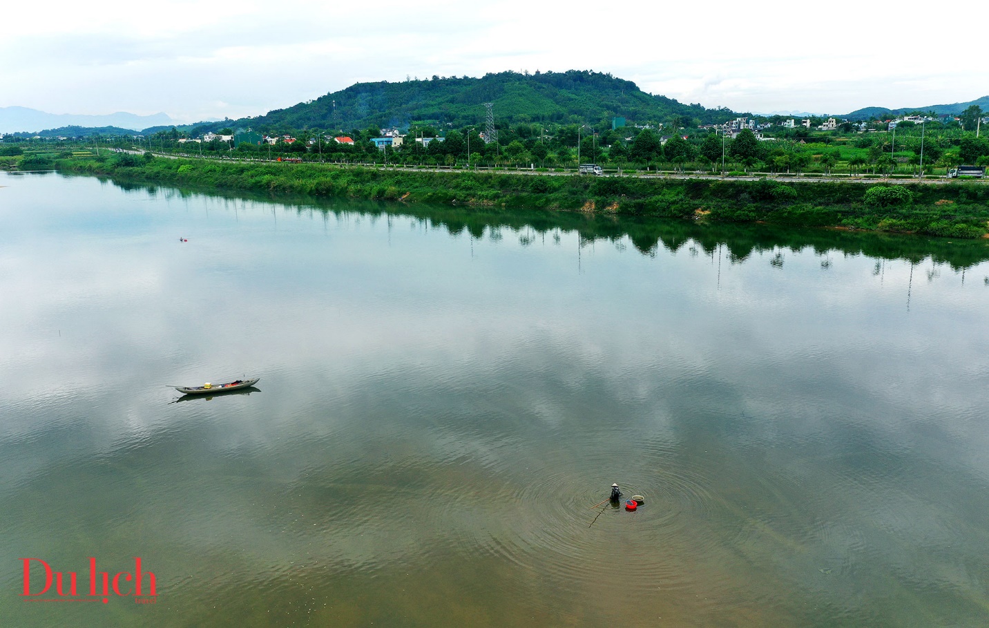 Aerial view of a river with a mountain in the background