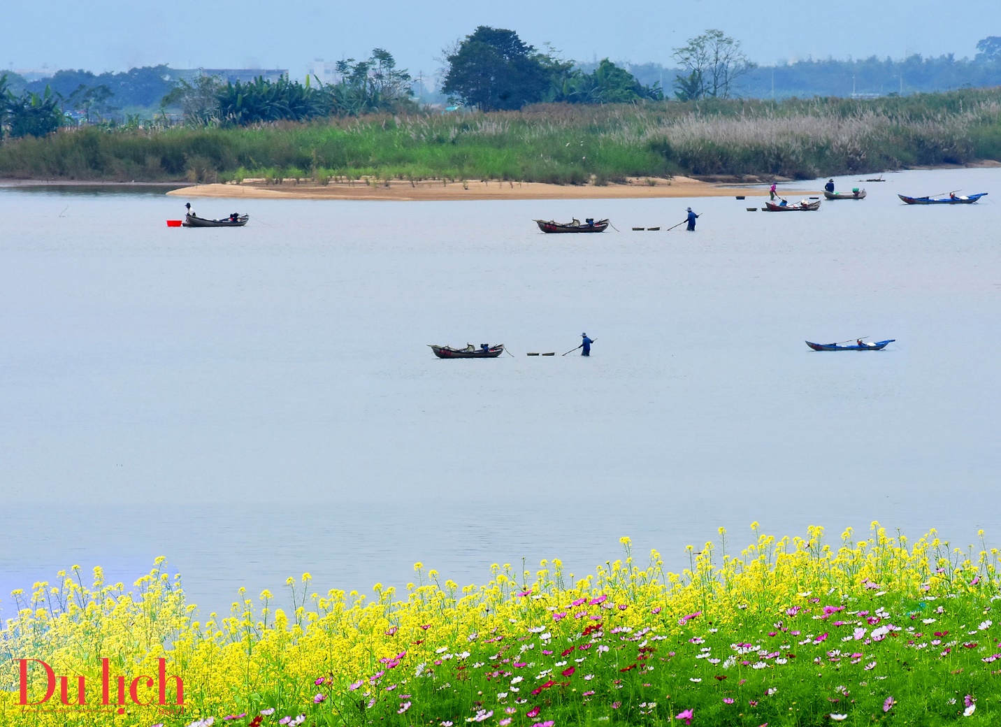 Scenic view of a river with mountains and fields in the background