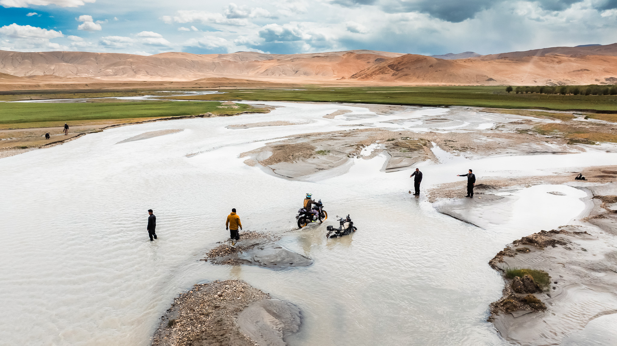 A small lake with slippery pebbles presents a challenge for travelers