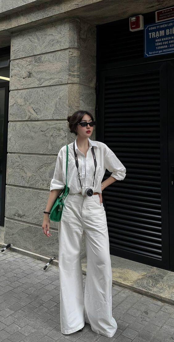 A woman wearing a white shirt and black pants, showcasing the "Chic Comfort" style.