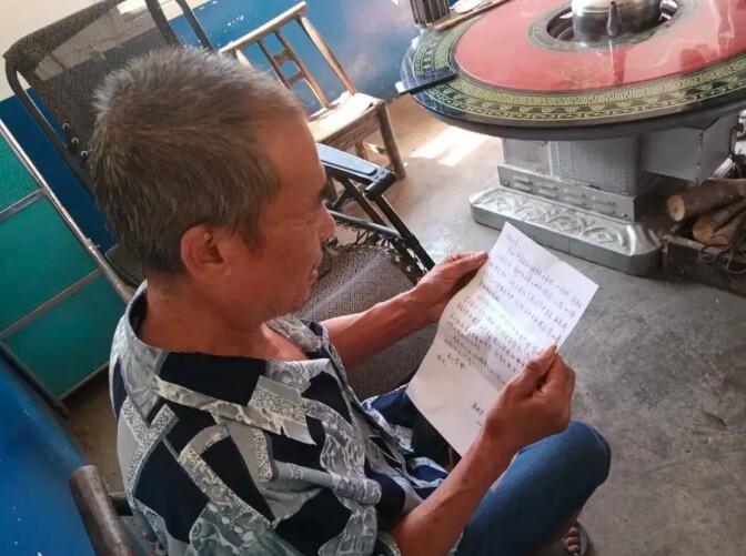 Người dân làng đọc thư cảm ơn nhận được (Nguồn: People’s Daily)