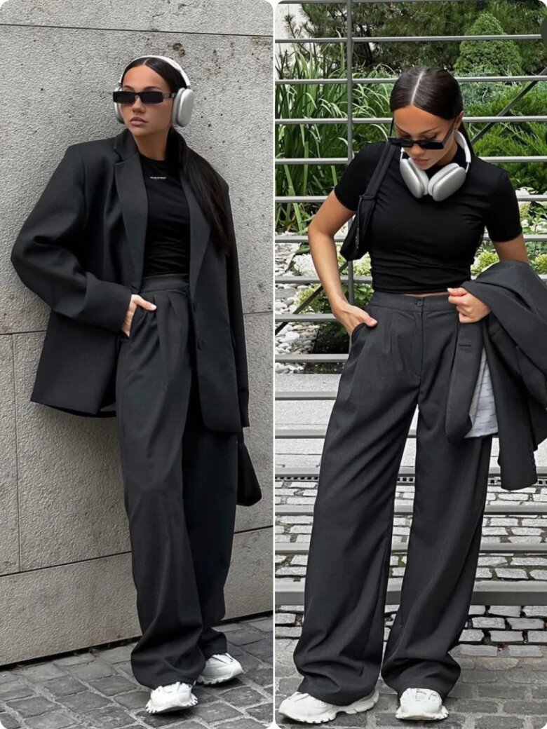 A woman wearing a cropped top, culottes, and an oversized blazer