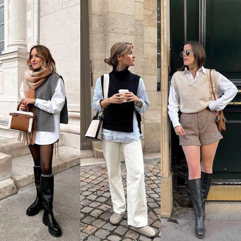 A woman wearing a beige sleeveless sweater, white shirt, blue jeans, and a black bag.