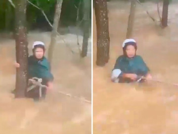 Bị nước cuốn trôi cùng xe máy, người phụ nữ được người dân ném dây thừng cứu sống