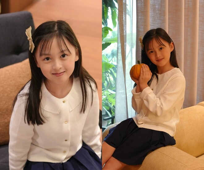 Cam Cam gây thiện cảm với gương mặt thanh tú, làn da trắng hồng và nụ cười nhẹ nhàng. Mái tóc đen dài buông xõa tôn thêm nét dịu dàng, trong sáng của cô bé.