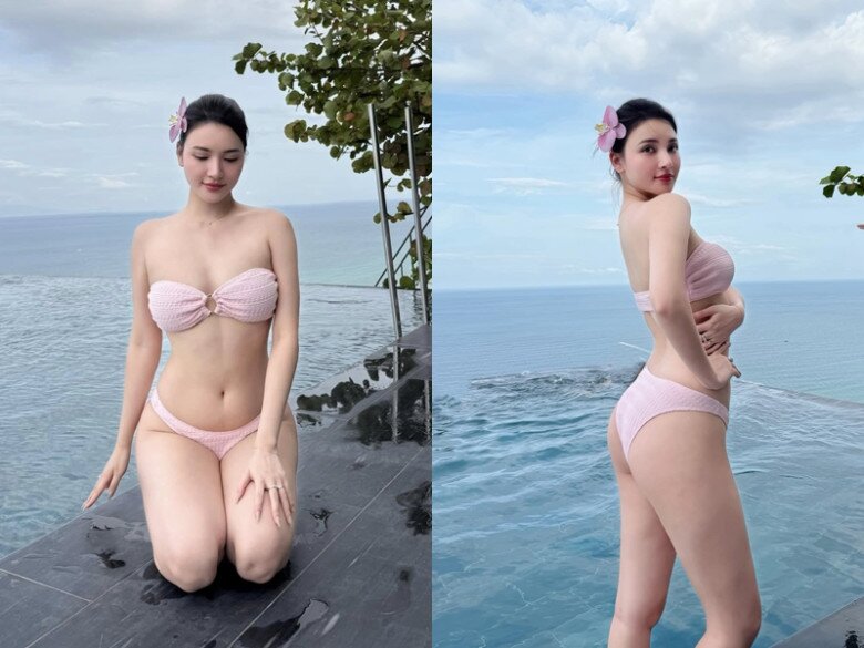 Trong bộ bikini bandeau màu hồng pastel, Bích Thủy khoe trọn bờ vai trần và vòng eo nhỏ nhắn. Thiết kế cúp ngực xoắn giữa tinh tế, kết hợp bông hoa cài tóc dịu dàng, vừa gợi cảm vừa nữ tính.