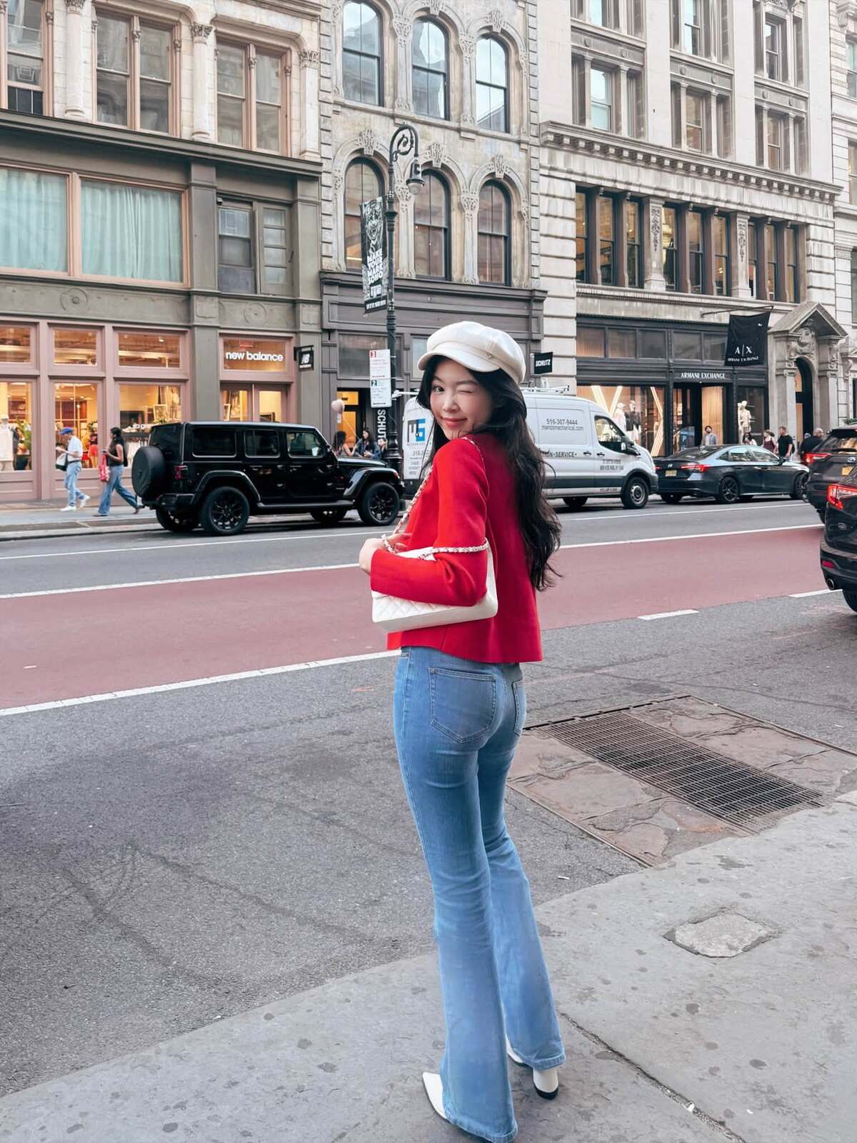 Set đồ gồm áo khoác len đỏ và quần jeans ống loe giúp Lọ Lem tôn đôi chân dài. Người đẹp mix loạt phụ kiện màu trắng tạo điểm nhấn.