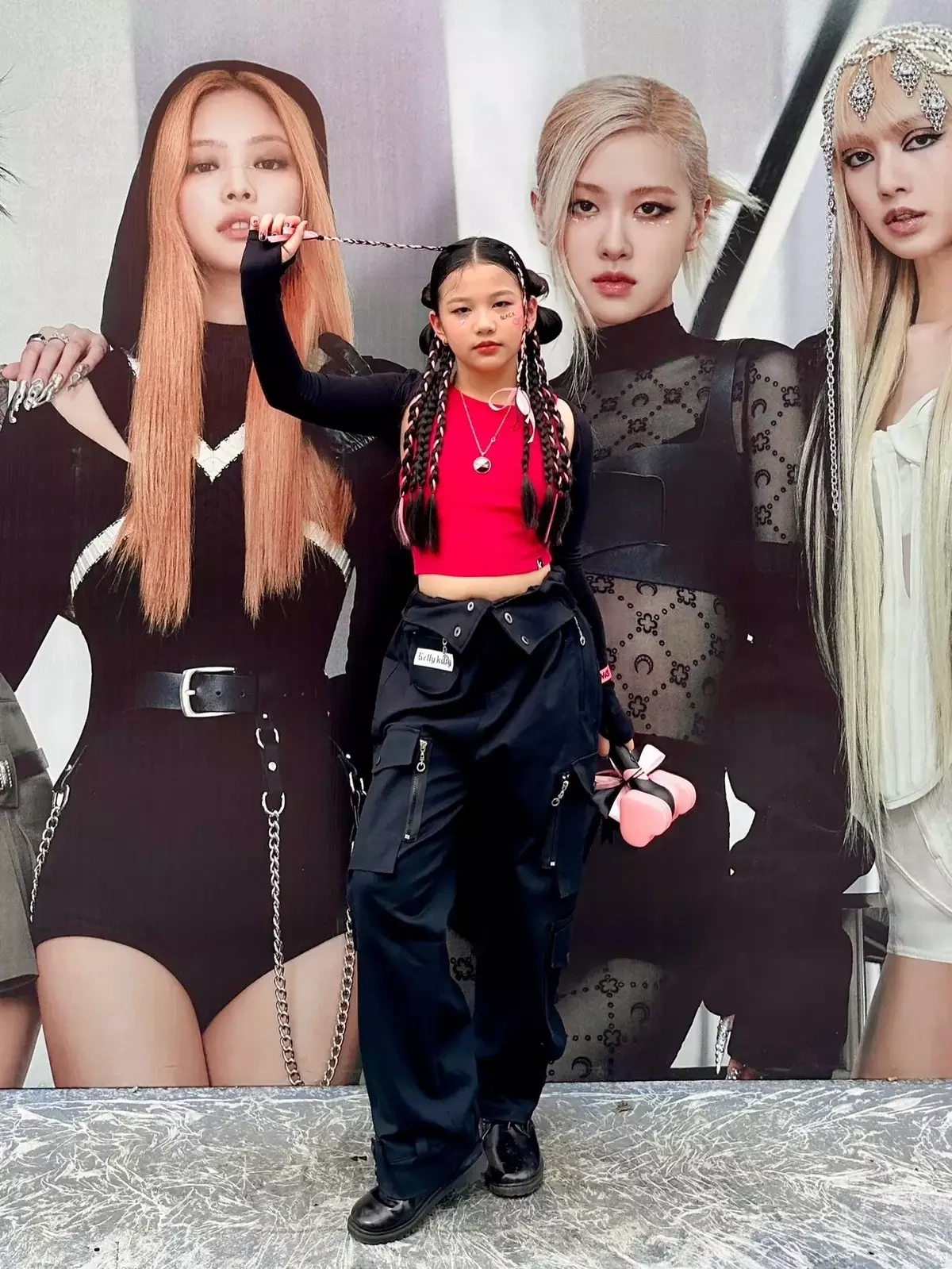 Trong chuyến đi xem Blackpink biểu diễn ở Hà Nội năm 2023, Na kết hợp quần cargo, crop top và áo khoác thun dài tay, trang điểm tông hồng kẹo ngọt với mái tóc tết.