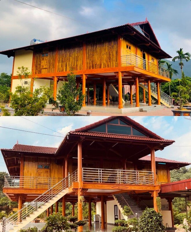 Căn nhà sàn bằng gỗ bao quanh bởi vườn tược, cây cối.